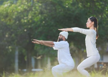 two-people-white-outfit-doing-yoga-nature