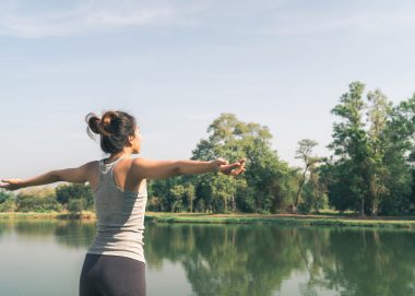young-asian-woman-yoga-outdoors-keep-calm-meditates-while-practicing-yoga